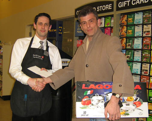 Image: Clerk handing over cookware set Image: Clerk handing over cookware set